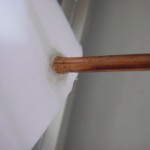 Copper coil protruding from the bottom of the bucket